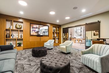 A living room with couches and chairs and a television